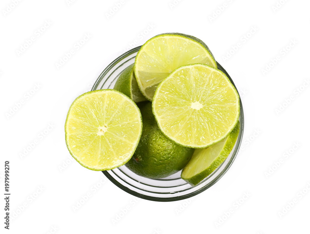 Lime slices in glass bowl isolated on white background, top view