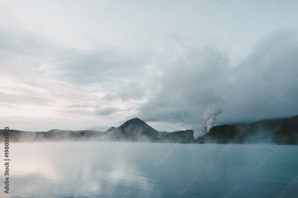 majestic icelandic seacoast with rocky mountains and steam from hot springs
