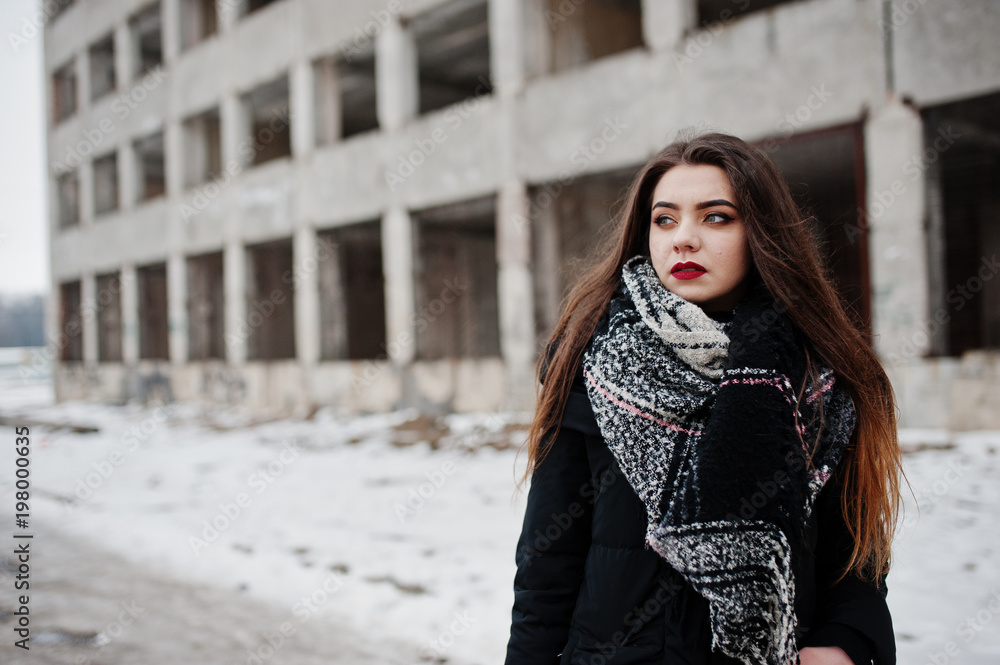 Brunette stylish casual girl in scarf against abandoned factory place.