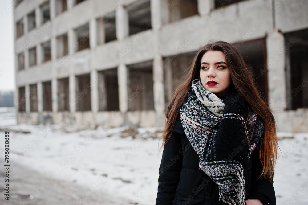 Brunette stylish casual girl in scarf against abandoned factory place. Brunette stylish casual girl in scarf against abandoned factory place.
