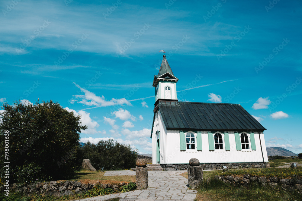 architecture of beautiful traditional church and old stone wall at sunny day, Pingvallakirkja, iceland architecture of beautiful traditional church and old stone wall at sunny day, Pingvallakirkja, iceland