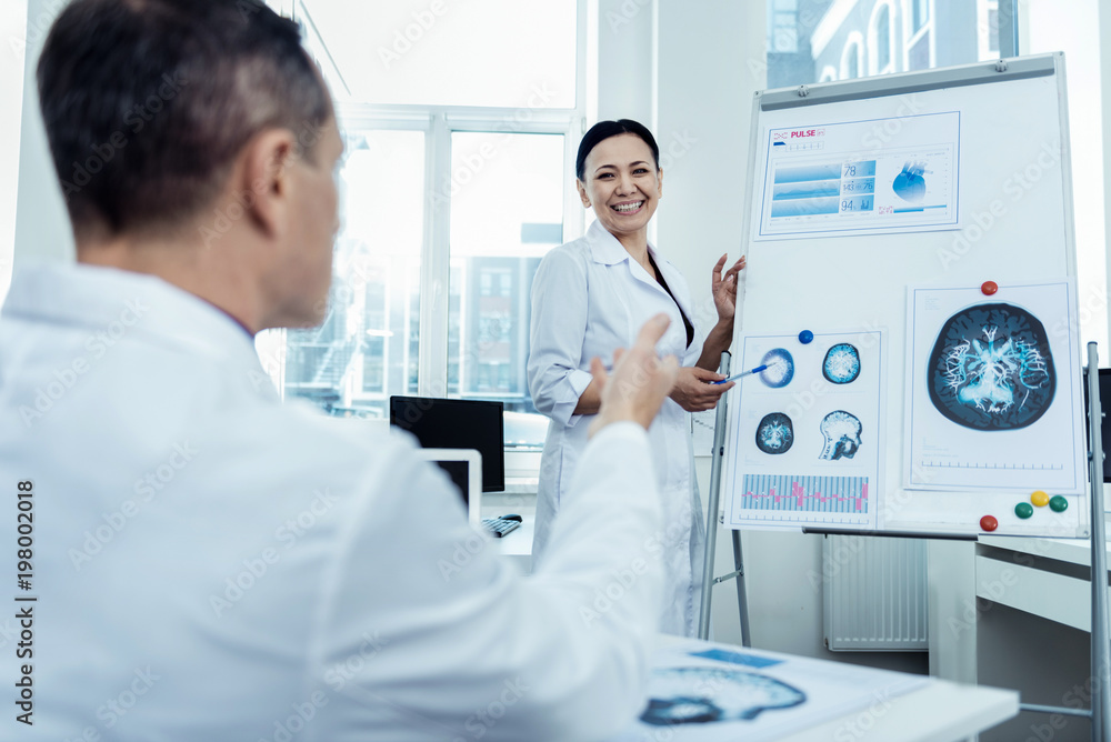 Study brainwaves. Professional asian scientist talking to her colleague abour neurology Study brainwaves. Professional asian scientist talking to her colleague abour neurology