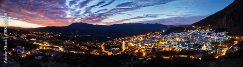 Panorama night city of Chefchaouen Morocco. Blue city in night lights. Journey through Morocco, magical place. Sunset over Chefchaouen, Morocco. Panoramic view of the city © angel_nt