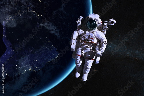 Fototapeta Naklejka Na Ścianę i Meble -  Astronaut in outer space on background of the night Earth. Elements of this image furnished by NASA.