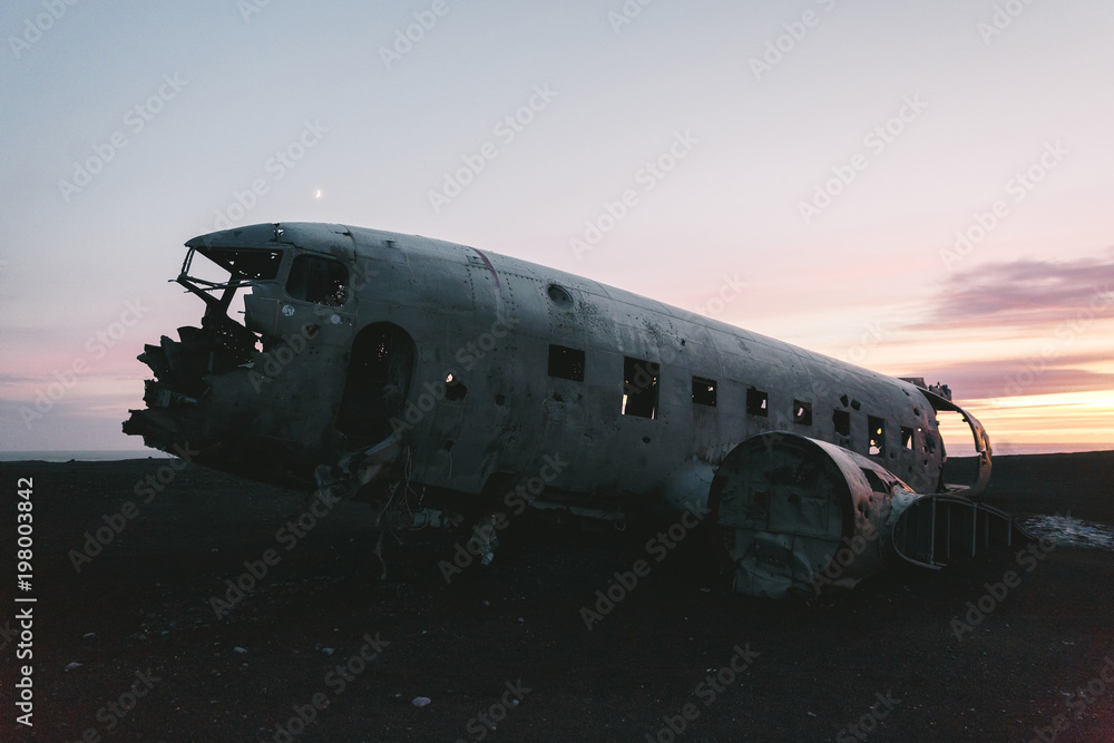 plane after air crash at sunset in iceland, solheimasandur plane wreck