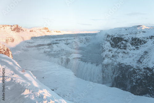 beautiful icelandic landscape with snow-covered rocks and Gullfoss waterfall