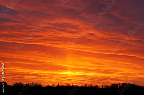 A bright evening sunset over a rural setting.