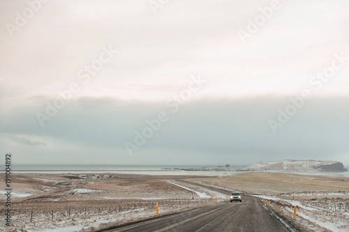 vehicle on road and beautiful snow-covered icelandic landscape