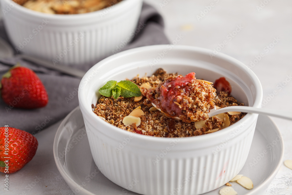 Homemade breakfast strawberry crumble. Mini berry cake with strawberry, macro, light background. Healthy vegan food concept. Homemade breakfast strawberry crumble. Mini berry cake with strawberry, macro, light background. Healthy vegan food concept.
