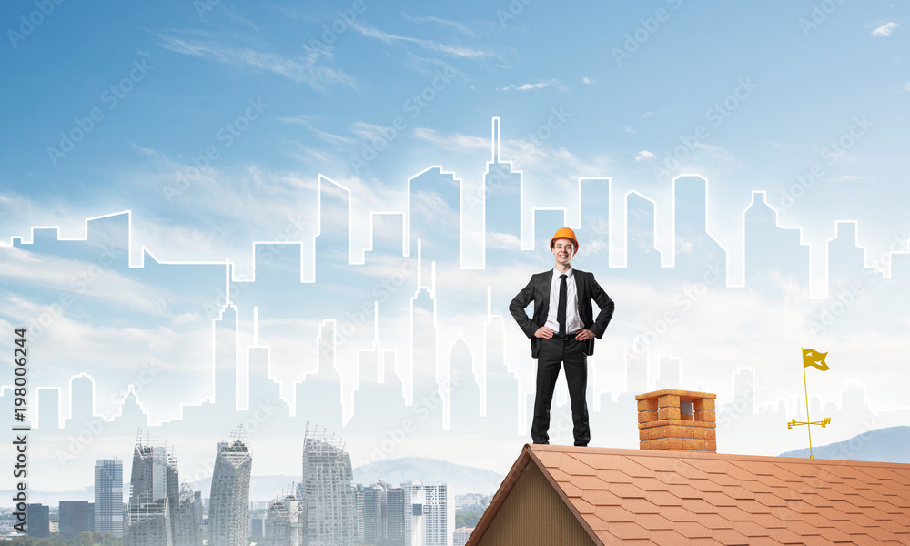 Engineer man standing on roof and looking away. Mixed media Engineer man standing on roof and looking away. Mixed media