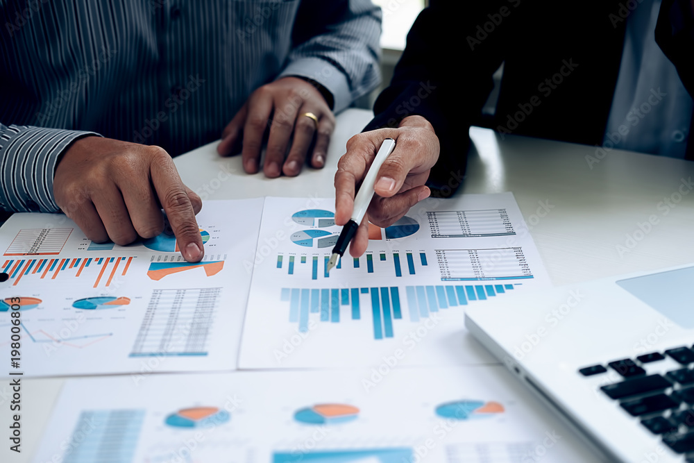 Business concept. Business people discussing the charts and graphs showing the results of their successful teamwork. Business concept. Business people discussing the charts and graphs showing the results of their successful teamwork.