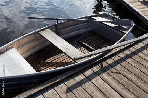 Docked metal and wooden boat on water photo