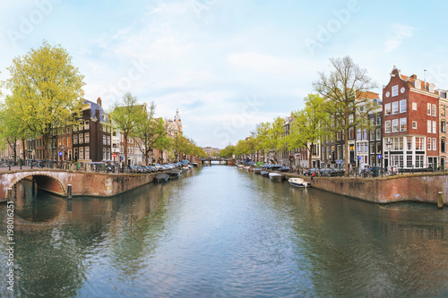 Photography Canals of Amsterdam. Sunset view of traditional bridge