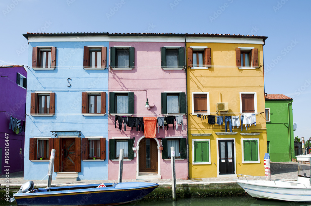 Burano island, Venice, Italy - colorful houses with hanging clothes