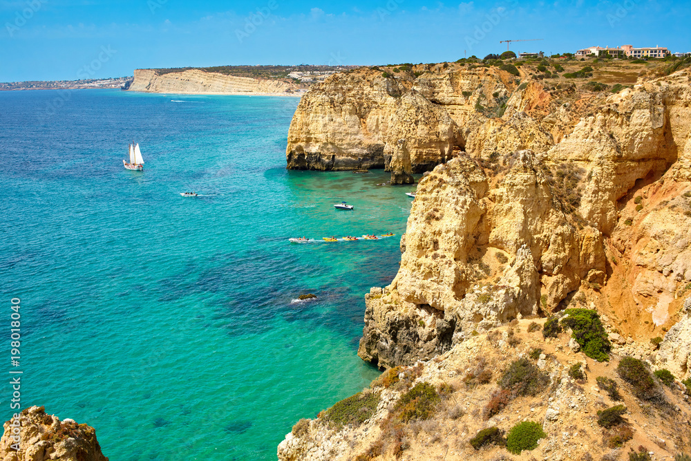 Cliff rocks and sea bay with turquoise water in Lagos, Algarve region, Portugal