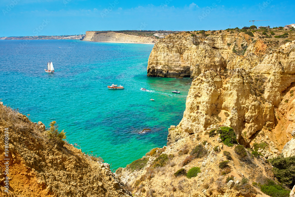 Cliff rocks and sea bay with turquoise water in Lagos, Algarve region, Portugal