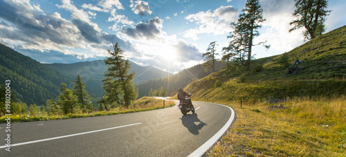Motorcycle driver riding in Alpine highway, Nockalmstrasse, Austria, Europe. © Lukas Gojda