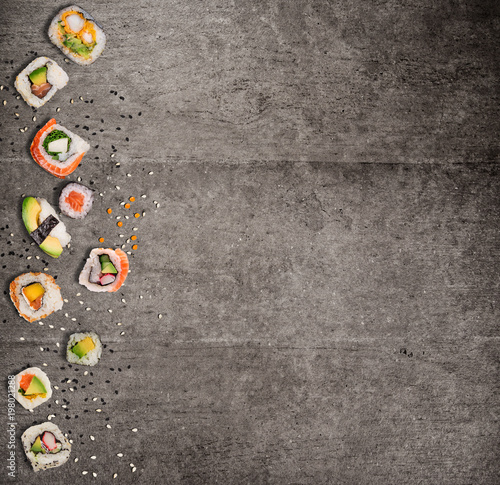 Traditional japanese sushi pieces on rustic concrete background.