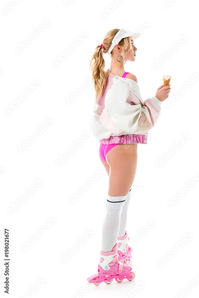 Young girl wearing pink roller skates and holding ice cream isolated on white Young girl wearing pink roller skates and holding ice cream isolated on white