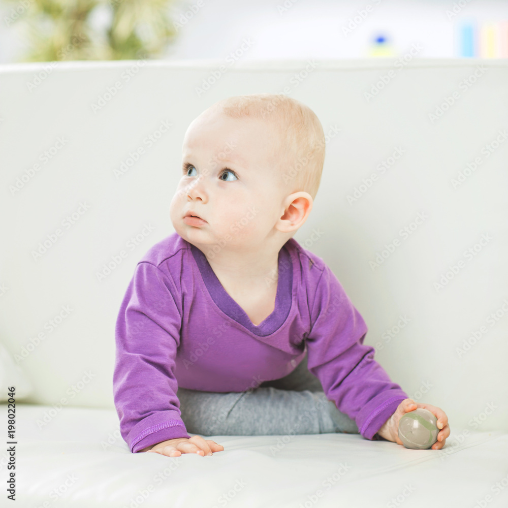 portrait of a happy one year old baby girl on a background of bright children's room portrait of a happy one year old baby girl on a background of bright children's room