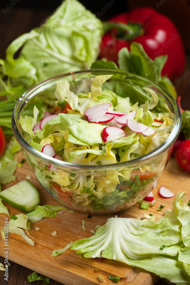 salad in a bowl of tomato, cucumber, cabbage vegetables for salad in the background, selective focus salad in a bowl of tomato, cucumber, cabbage vegetables for salad in the background, selective focus