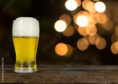 cold beer on the table wood and blur ligh background