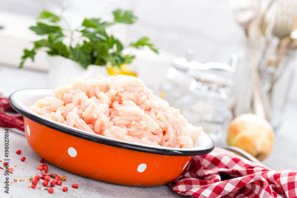 Forcemeat. Raw ground chicken meat in bowl on white kitchen table. Fresh minced chicken breast meat Forcemeat. Raw ground chicken meat in bowl on white kitchen table. Fresh minced chicken breast meat