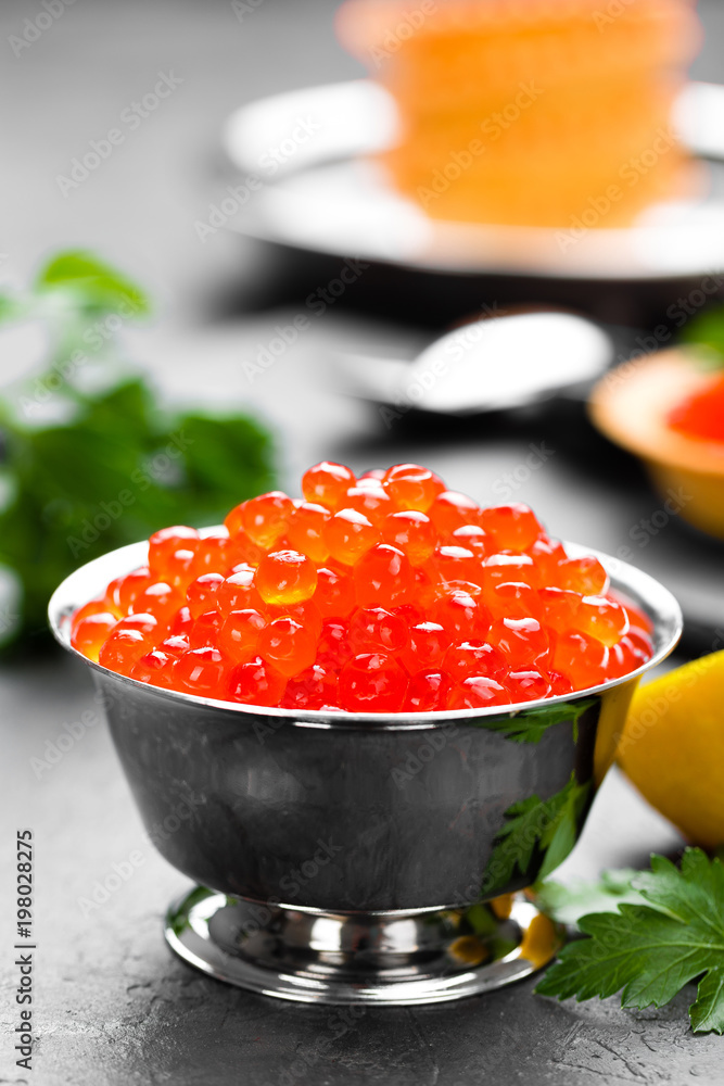 Red salmon fish caviar, salmon caviar in metal bowl. Caviar. Selective focus Red salmon fish caviar, salmon caviar in metal bowl. Caviar. Selective focus