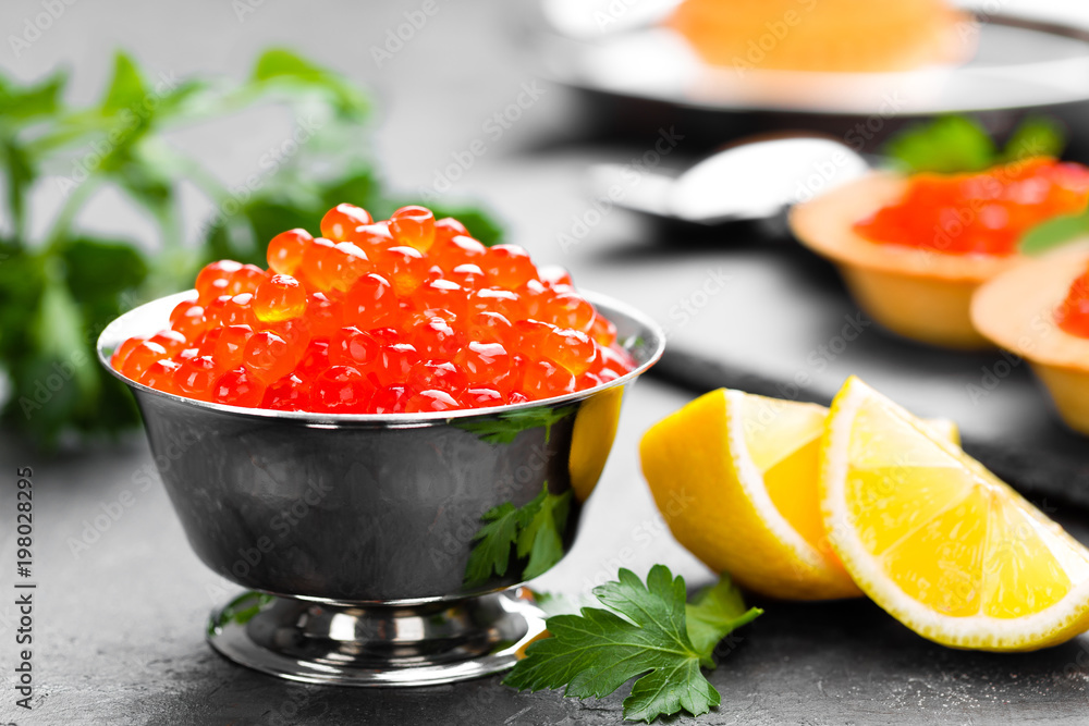 Red salmon fish caviar, salmon caviar in metal bowl. Caviar. Selective focus Red salmon fish caviar, salmon caviar in metal bowl. Caviar. Selective focus