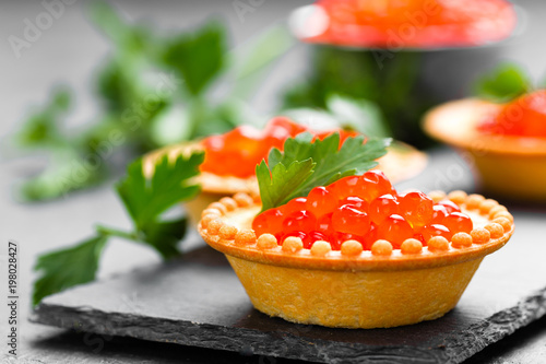Tartalets with red salmon fish caviar, salmon caviar. Caviar. Selective focus