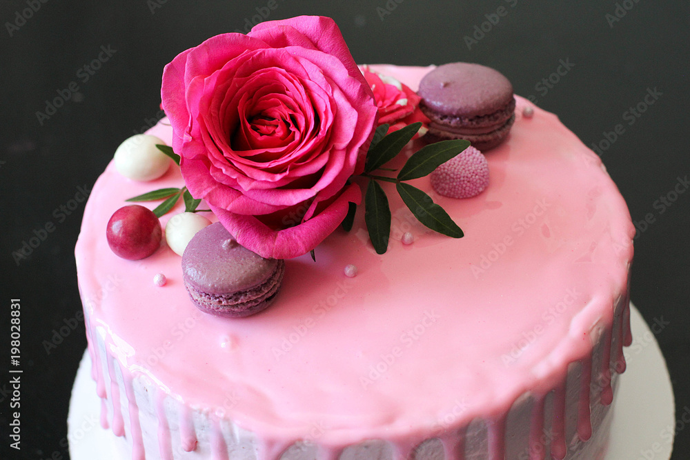 Tasty pink homemade cake decorated by rose and macarons Tasty pink homemade cake decorated by rose and macarons