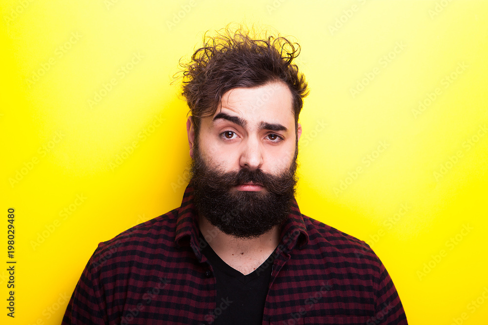 Obraz premium Portrait of man with long beard on yellow background in studio photo