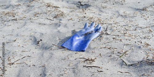 Laesoe / Denmark: A lost blue rubber glove lying in the dunes at Bloeden Hale