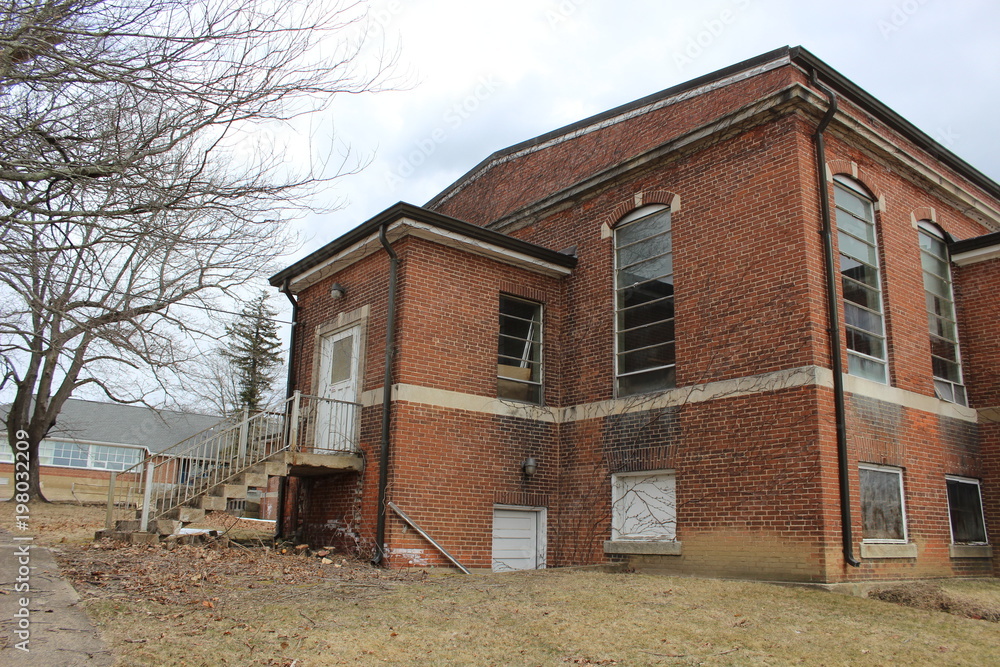 Old abandoned and boarded up brick asylum hospital building Old abandoned and boarded up brick asylum hospital building