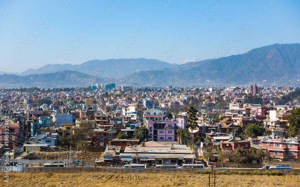 Part of Kathmandu city as seen from a vantage point, Nepal. Hills and mountains in the background.