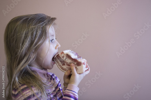 Girl biting a piece of fresh meat