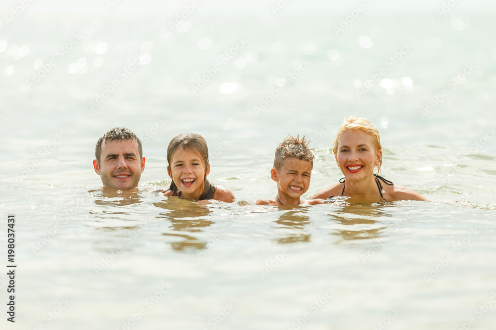 Fototapeta premium beautiful happy family swimming in sea together