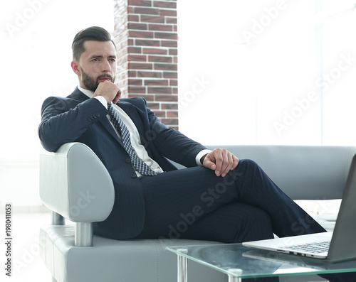 businessman sitting at a coffee table in the lobby