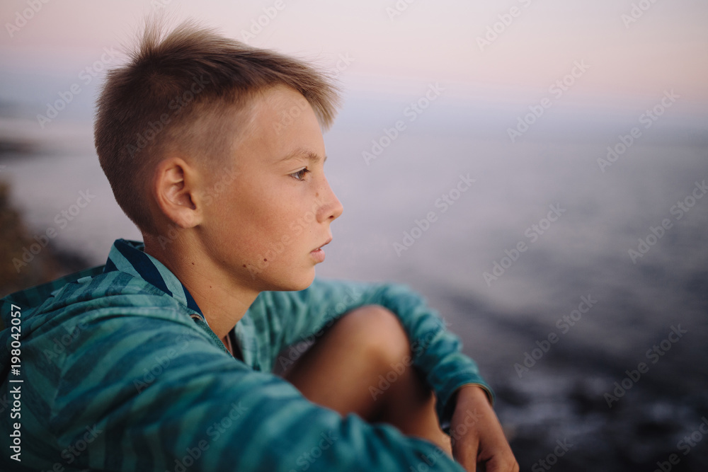 Portrait of a boy looking at the sea. soft focus on eyes Portrait of a boy looking at the sea. soft focus on eyes