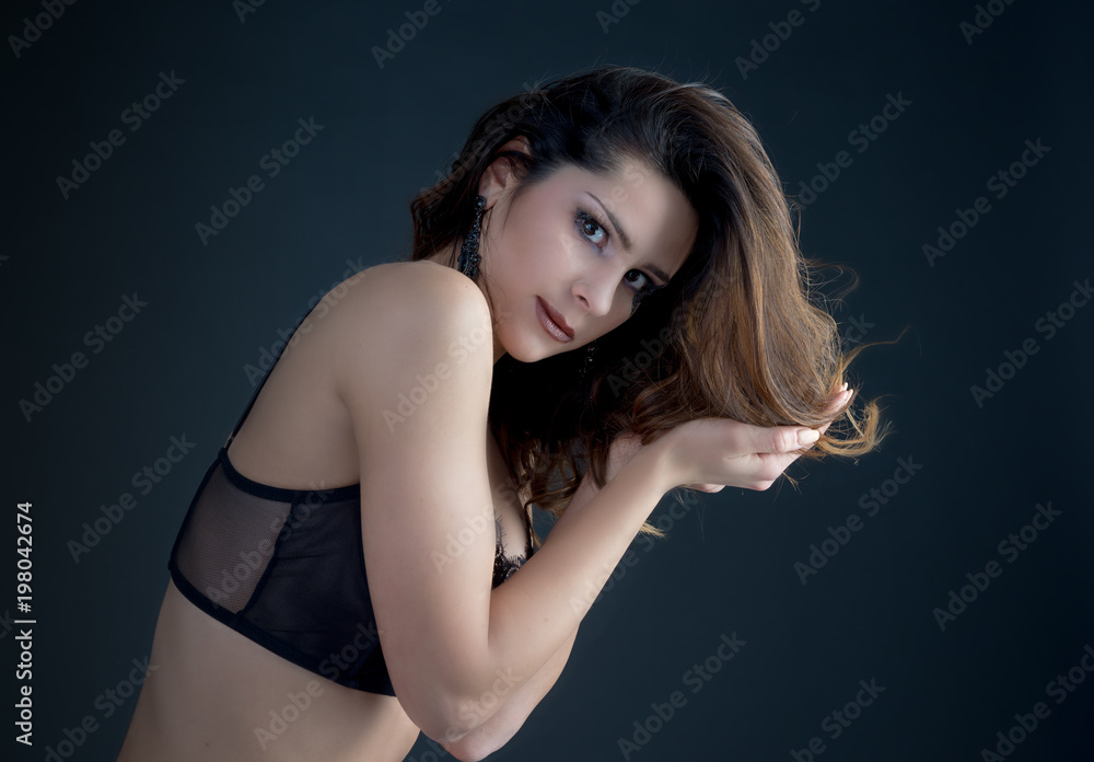 Naklejka premium cute girl posing on dark background