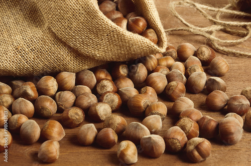 Hazelnuts in a yuta bag on wooden table