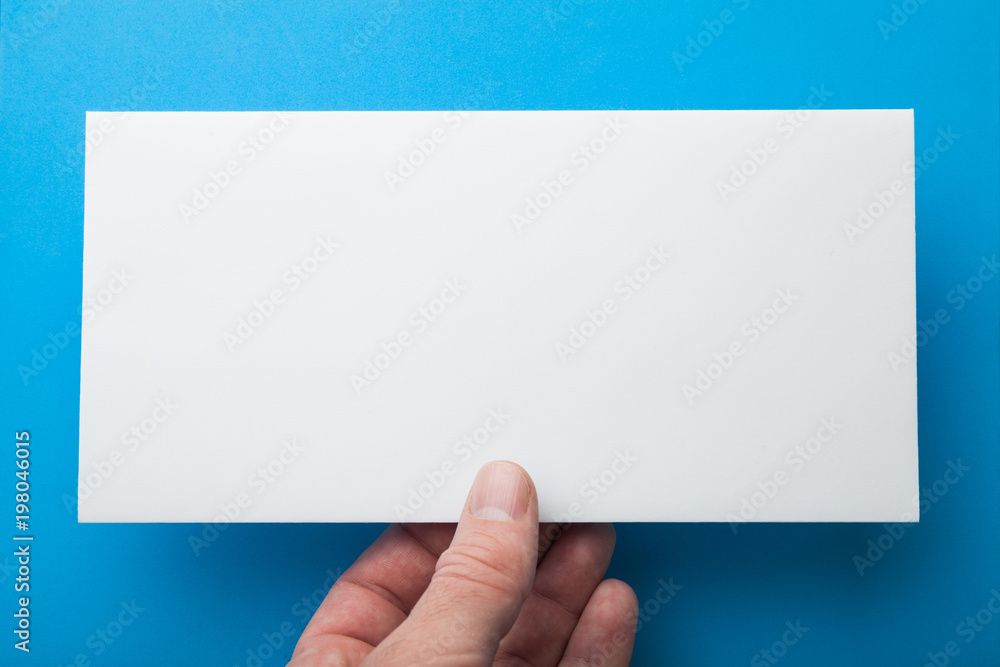 Fototapeta premium Mail envelope or DL flyer in hand.
