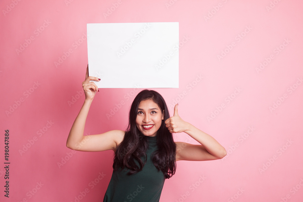 Young Asian woman show thumbs up with white blank sign. Young Asian woman show thumbs up with white blank sign.