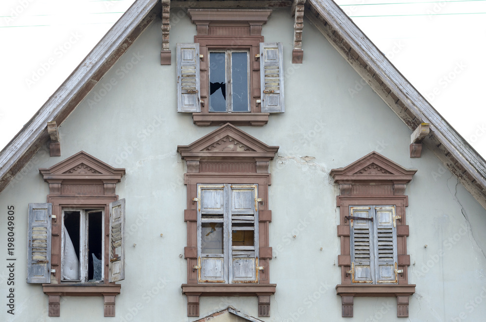 Fototapeta premium End gable and windows of an old abandoned house