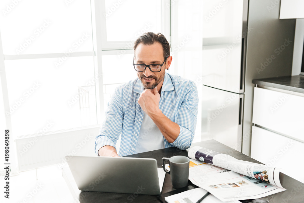 Handsome mature man using laptop computer Handsome mature man using laptop computer