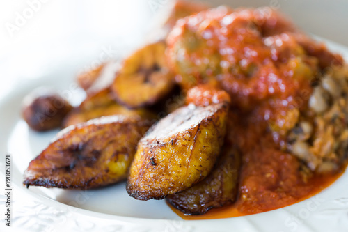 Nigerian Brown Bean Porridge (Ewa Agoyin) with fried Plantain   photo