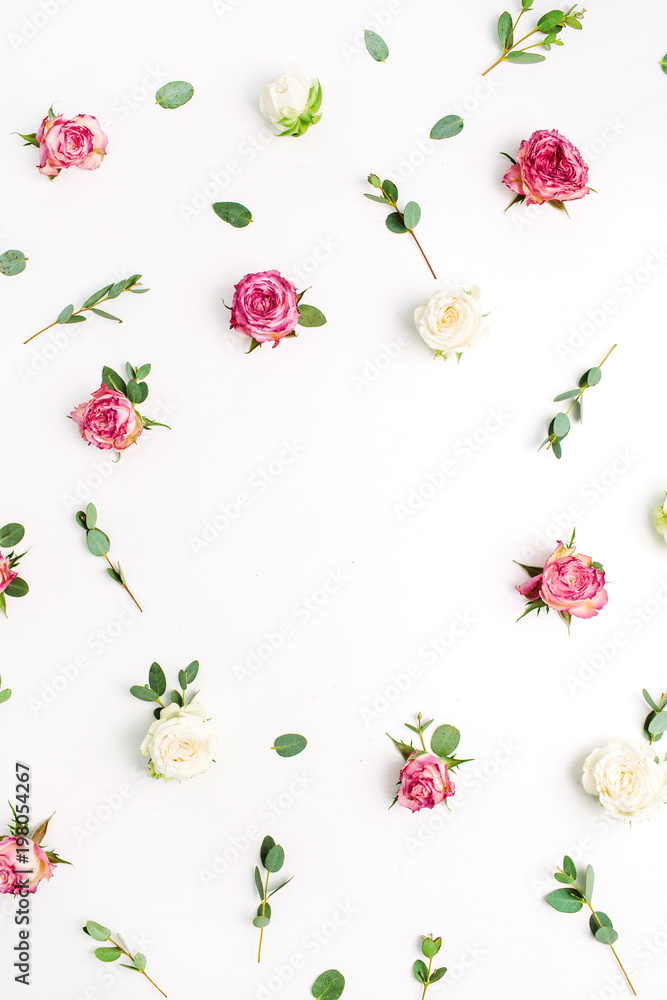 Fototapeta premium Floral frame of rose flowers and eucalyptus branches on white background. Flat lay, top view festive flowers mockup with copy space.