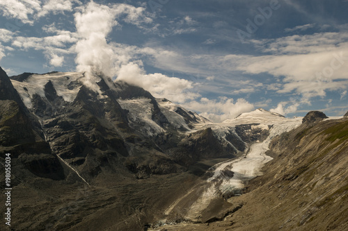 Snow and ice covered mountain covered by cloud