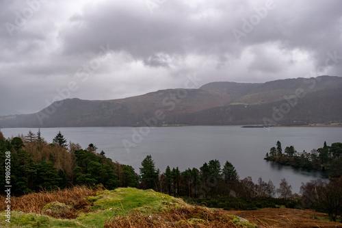 Cloudy lakeside view towards hills in Cumbria
