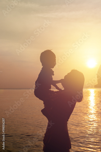 Mother and Son Silhouette with Sunset Background  Using for Family Concept.